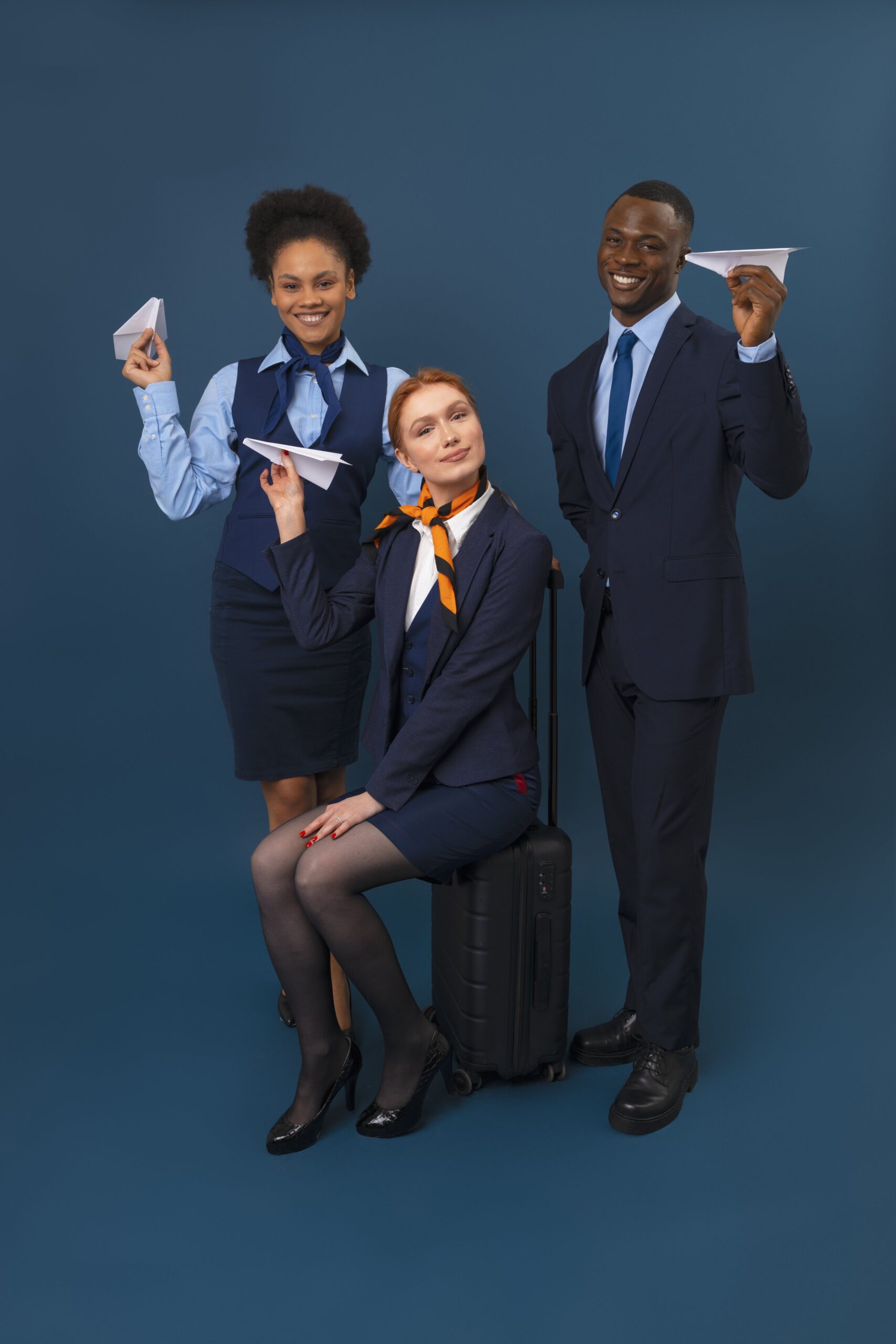 full shot flight attendants with baggage min